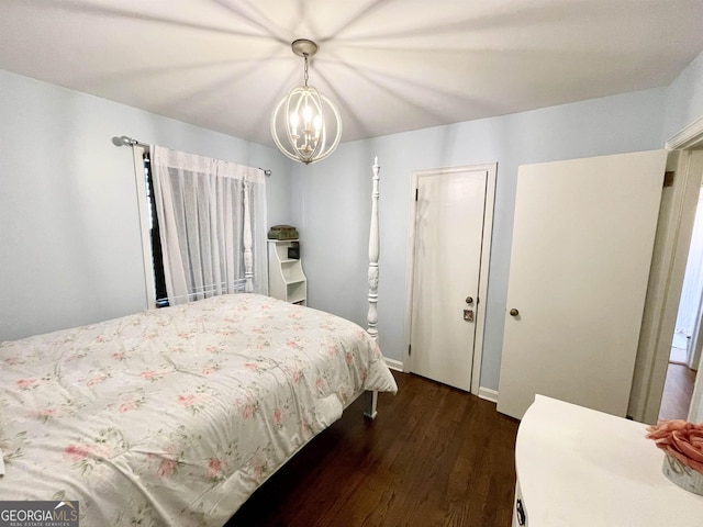 bedroom with dark wood-style floors and a chandelier