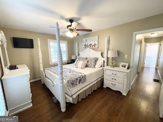 bedroom featuring ceiling fan, visible vents, baseboards, and dark wood-type flooring