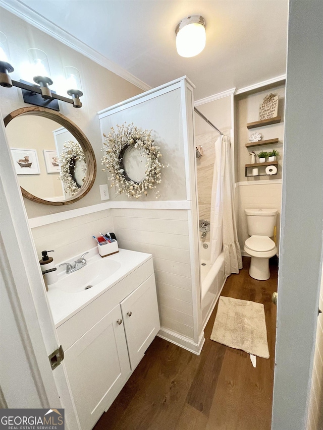 full bathroom with shower / bath combo, toilet, ornamental molding, wood finished floors, and vanity