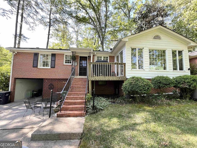 view of front of property featuring a garage, brick siding, driveway, stairway, and a patio area