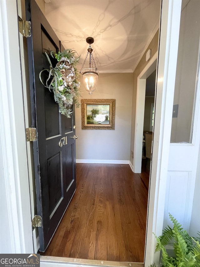 interior space with dark wood-style floors, baseboards, and crown molding