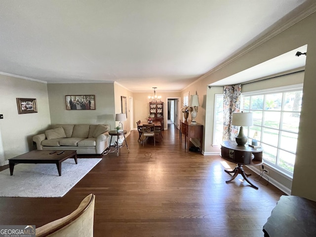 living room with baseboards, ornamental molding, dark wood finished floors, and a notable chandelier