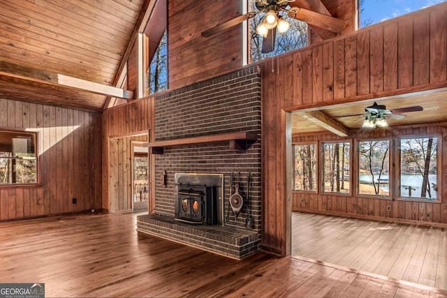 unfurnished living room featuring wood finished floors, wood ceiling, and wooden walls