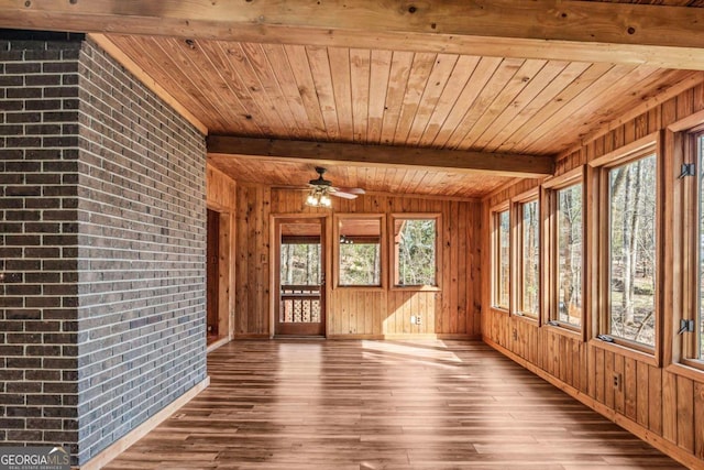 unfurnished sunroom with wood ceiling, beam ceiling, and ceiling fan