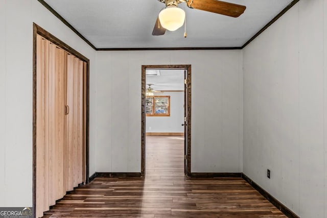 interior space with ceiling fan, ornamental molding, and dark wood finished floors