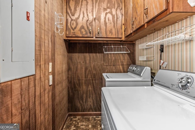 laundry room featuring cabinet space, electric panel, and independent washer and dryer