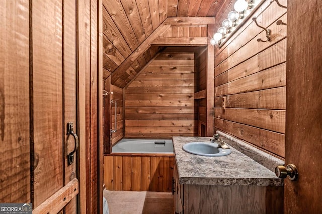 full bathroom with a tub to relax in, wood ceiling, wooden walls, and vanity