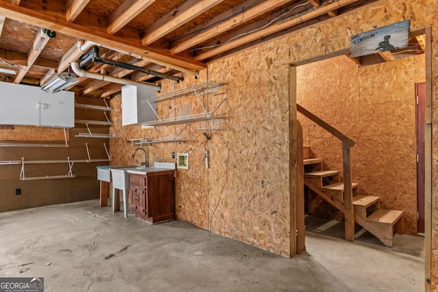 basement featuring stairway and a sink