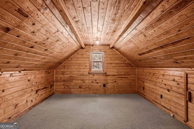 additional living space with lofted ceiling, wooden ceiling, carpet, and wood walls