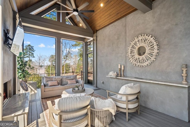 sunroom featuring lofted ceiling with beams