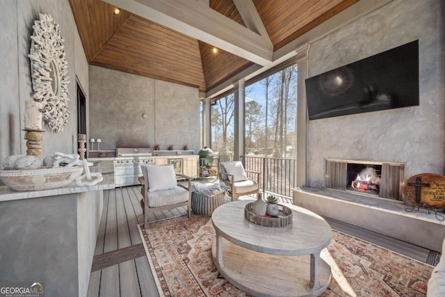 sunroom / solarium with a high end fireplace, lofted ceiling, and wood ceiling