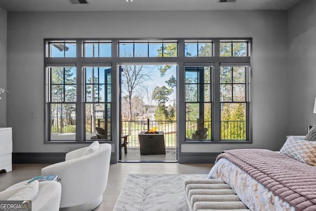 bedroom with access to outside, multiple windows, and visible vents