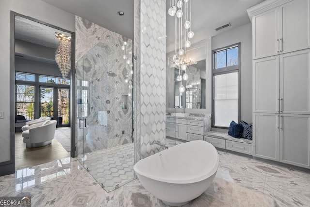 full bath with marble finish floor, plenty of natural light, vanity, and visible vents