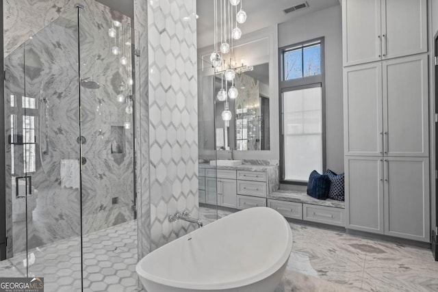 full bath with a soaking tub, a marble finish shower, visible vents, and vanity