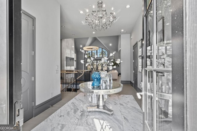 entrance foyer featuring baseboards, a chandelier, and recessed lighting