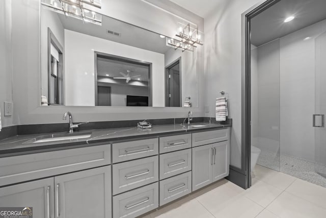 full bathroom with a stall shower, visible vents, a sink, and double vanity