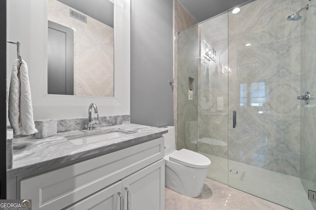 bathroom featuring toilet, vanity, visible vents, and a shower stall