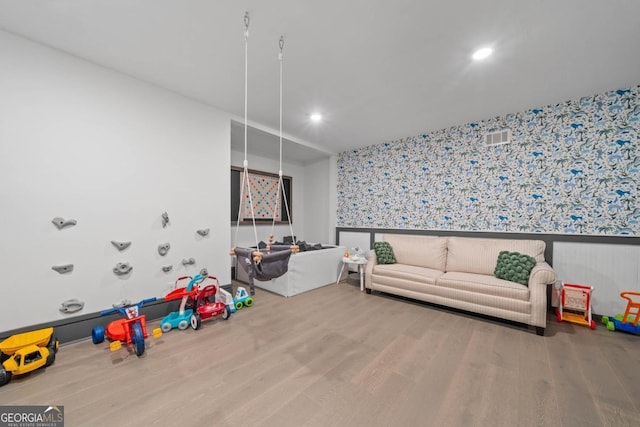 playroom featuring recessed lighting, wood finished floors, visible vents, wainscoting, and wallpapered walls