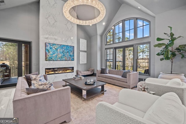 living room with high vaulted ceiling, recessed lighting, visible vents, and a premium fireplace