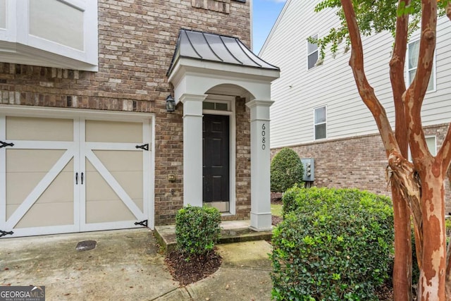 entrance to property featuring a standing seam roof, brick siding, and metal roof