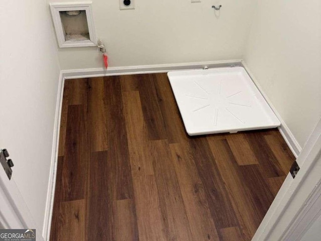 clothes washing area with baseboards, hookup for a washing machine, and hookup for an electric dryer