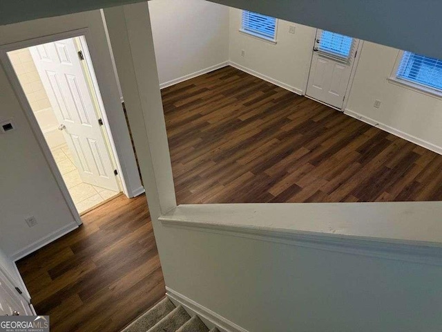 interior space with baseboards and wood finished floors