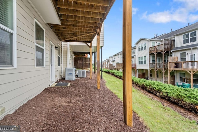 view of yard featuring a residential view and central AC