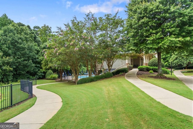 view of front of home with a front yard and fence