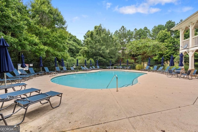 pool featuring a patio and fence