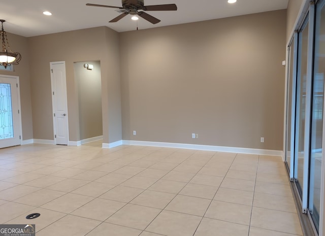 unfurnished room featuring a ceiling fan, recessed lighting, baseboards, and light tile patterned floors