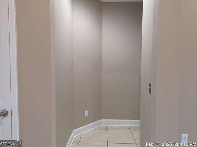 interior space with baseboards and light tile patterned floors