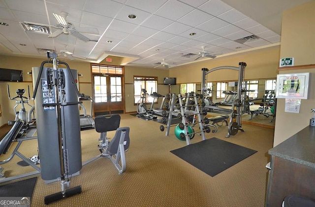 gym with ceiling fan, french doors, a drop ceiling, and visible vents