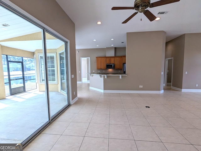 unfurnished living room with light tile patterned floors, baseboards, visible vents, a ceiling fan, and recessed lighting