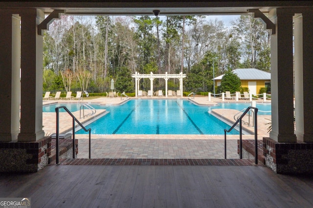 pool featuring a pergola and a patio