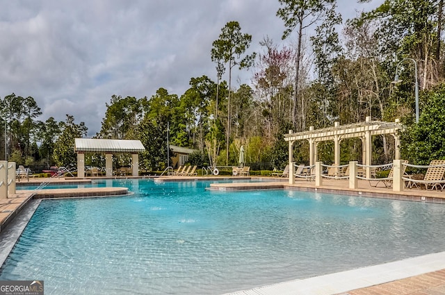 community pool with a gazebo and a pergola