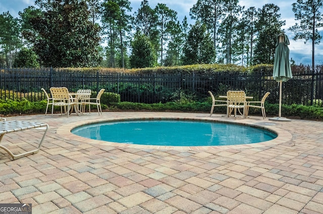 view of pool with a patio area, fence, and a fenced in pool