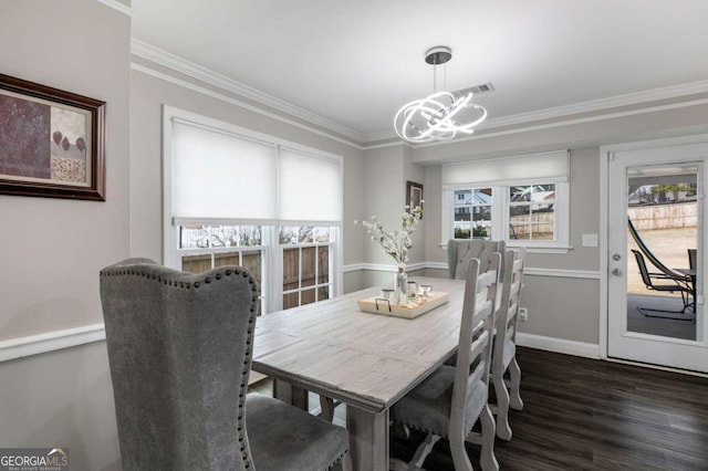 dining room featuring a chandelier, a wealth of natural light, and ornamental molding