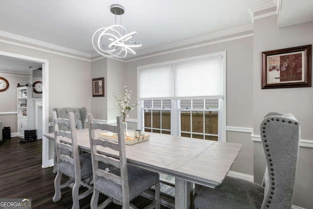 dining area with ornamental molding, dark wood finished floors, baseboards, and an inviting chandelier