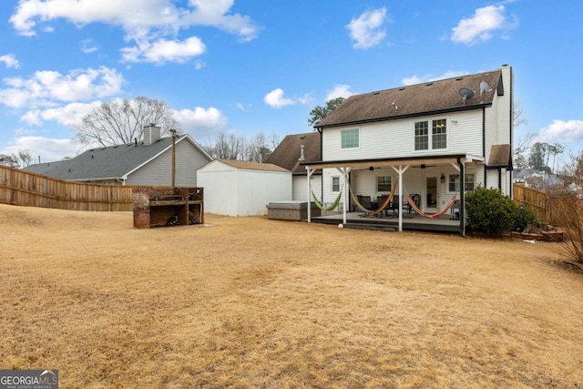 back of house with a patio area, a storage unit, an outdoor structure, and a fenced backyard