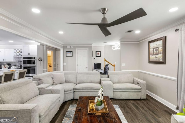 living area featuring dark wood-type flooring, visible vents, crown molding, and a ceiling fan