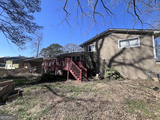 view of home's exterior with a deck and stairway