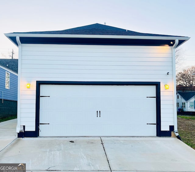 garage featuring concrete driveway