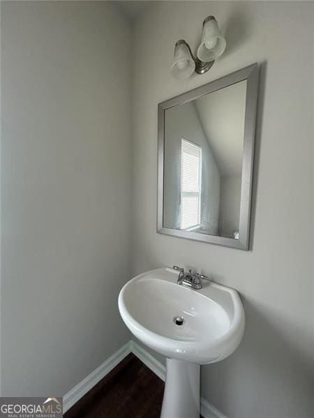 bathroom featuring baseboards and wood finished floors