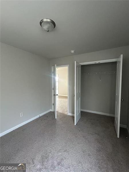 unfurnished bedroom with a closet and baseboards