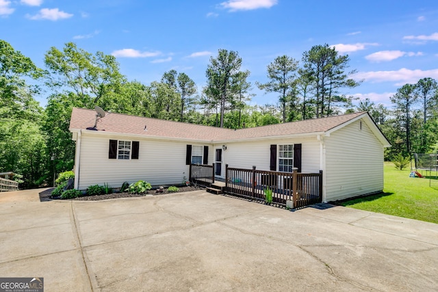 single story home featuring a wooden deck