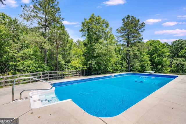 view of pool with a fenced in pool and fence