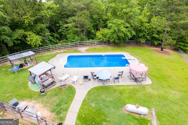 view of swimming pool featuring a fenced backyard, a lawn, and a gazebo