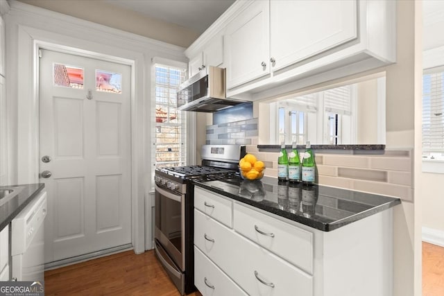 kitchen with stainless steel appliances, tasteful backsplash, dark wood-type flooring, white cabinets, and dark stone counters