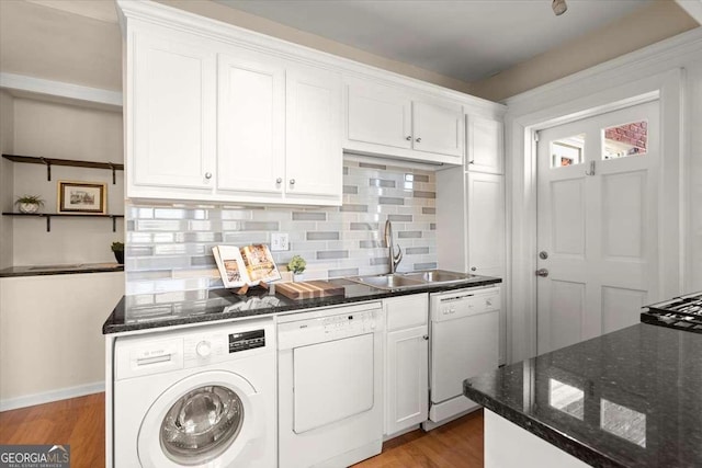 kitchen with a sink, washer / dryer, white cabinets, and dishwasher