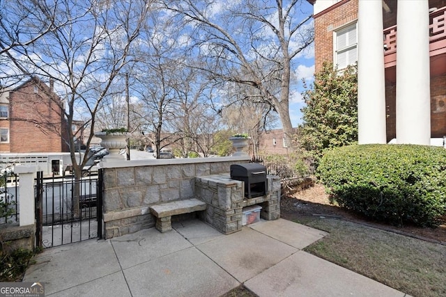 view of patio / terrace featuring a grill, an outdoor kitchen, and fence